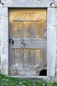 破旧的破旧木制门石头入口铁工房子建筑物木头石工金属门框风化图片