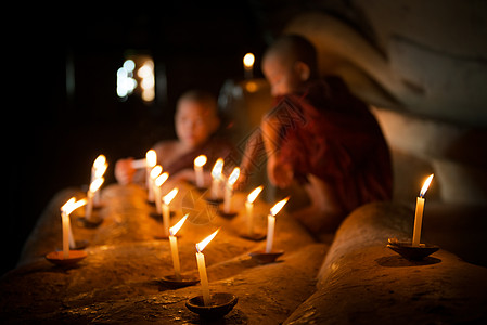 寺庙内点着蜡烛的佛教新手图片