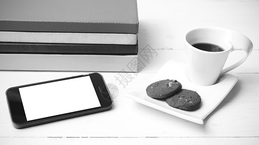 咖啡杯加饼干 手机和书卷黑白可乐眼镜笔记本杯子桌子咖啡工作钥匙电话办公室细胞背景图片