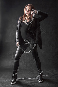 身穿黑色黑衣 带链条的年轻女子女性夹克黑暗野蛮皮革头发数字训练力量岩石图片