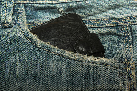 口袋中的钱包物品皮革黑色牛仔裤蓝色艺术背景图片