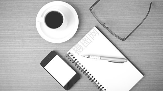 咖啡 电话 笔记和眼镜日记笔记本商业写作职场桌子手机白色办公室工作背景图片