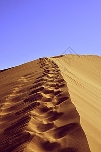 摩洛哥的撒哈拉沙漠小丘冒险口渴海浪蓝色沙漠日落太阳旅行地形图片