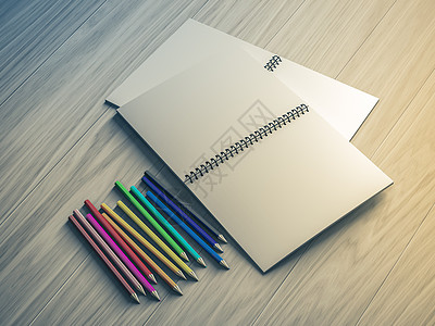 在木材背景上检查过的笔记本上的彩色铅笔夹子蓝色图钉学校木头金属文档办公室网格金子图片