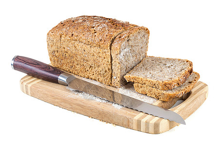 在切肉板上切全餐面包和刀棕色木头脆皮早餐美食木板小麦玉米厨房面粉图片