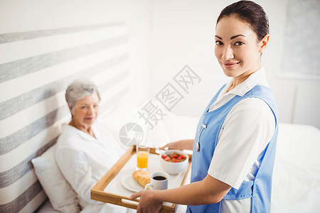 护士给高龄妇女提供早餐图片