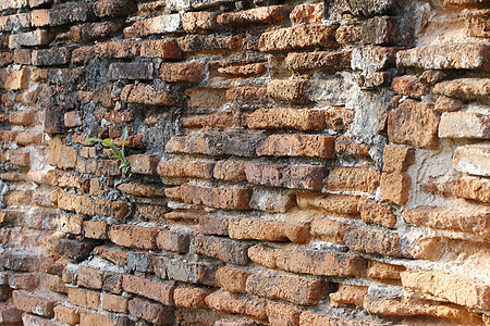 泰国的旧砖墙背景石匠岩石水泥城市建筑学黏土建筑师石头橙子斑点图片
