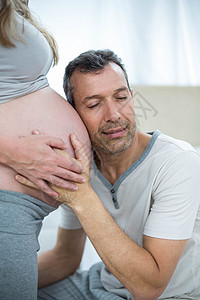男人倾听孕妇的胃部卧室孕产孕妇装卫生感情家庭家庭生活身份亲密感听力图片