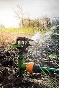 特写喷洒器农业地面花园洒水器灌溉喷射草皮软管生态肥料图片