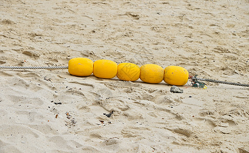 沙滩上四个黄色标记浮标海滩缆绳灯塔电缆图片