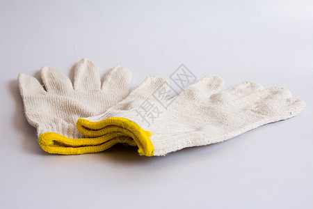 白色的棉花手套在白色背景上被隔离纤维衣服门户工具羊毛安全工作手指制造婴儿图片