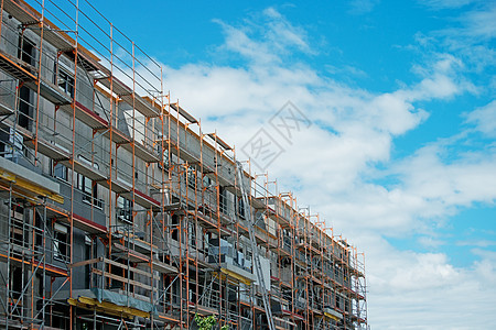 建造多层建筑的建筑物框架住房水泥住宅天空构造房子脚手架技术金属图片