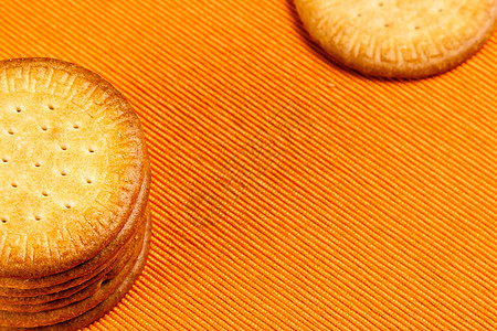 橙色布上自制的饼干燕麦蛋糕棕色麦片芯片团体小麦橙子早餐营养图片