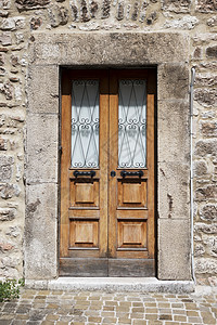 典型的意大利门石头建筑学房子棕色风化建筑木头古董入口图片