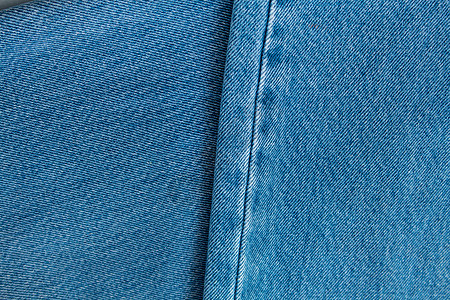 旧牛仔裤背景的质地织物扣子条纹帆布按钮国家口袋棉布边界蓝色图片
