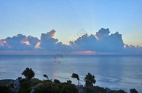 地中海上空的太阳升起植物海岸地平线石头天空图片