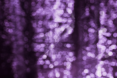 紫紫色抽象光辉闪耀的亮光布基背景紫色辉光火花闪光图片