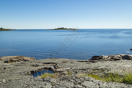 海洋沿岸地平线岩石悬崖树木支撑天空石头图片