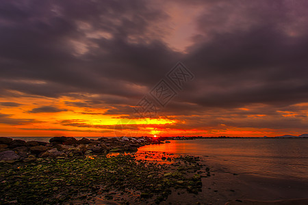 玛丽娜迪马萨的日落橙子白色灯光海岸风景红色明信片蓝色海滩岩石图片