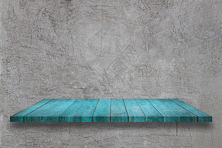 灰色混凝土纹理背景上的顶蓝色木板桌图片