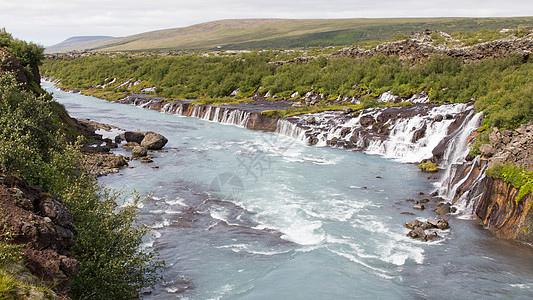 冰岛的Hraunfossar瀑布蓝色火山运动流动裂缝石头峡谷力量溪流山脉图片