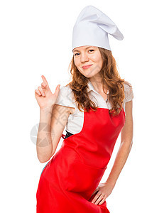 穿着围裙和厨帽的漂亮女孩的垂直肖像图片