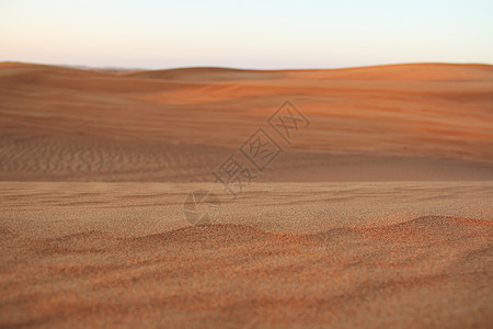 迪拜沙漠景观场景荒野天空太阳海浪橙子日落地平线旅游土地图片