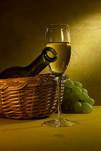 白酒在玻璃和葡萄中瓶子作品食物酒杯棕色绿色饮料藤蔓黄色篮子图片