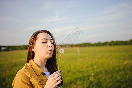 快乐的年轻女孩 享受阳光明媚的春天成人闲暇草地头发自由女性乐趣喜悦场地幸福图片