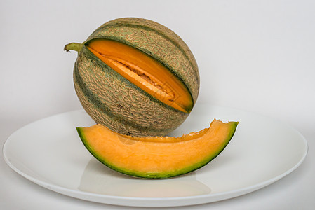 白底带切片的成熟甜瓜种子西瓜蔬菜饮食热带农业果皮橙子水果图片