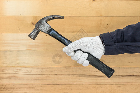 手里握着锤子的手套黑色工人维修木匠作用金属构造乐器手工具工业图片