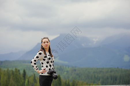 女摄影师在山上拍照片摄影远足女士假期相机远足者背包游客女性冒险图片