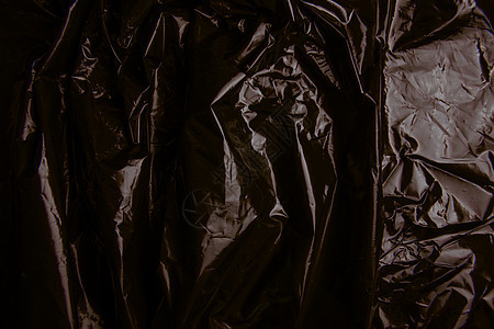 被弄皱的塑料影片纹理回收材料包装空白黑色包装纸皱纹背景图片