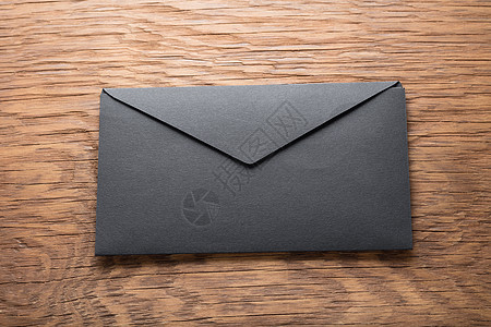 木桌上的黑色信封卡片邮件空白商业邮政桌子公司笔记文档办公室图片