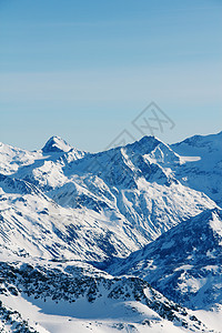 阳光明媚的寒冬山蓝色顶峰天空全景白色高山滑雪冰川岩石图片