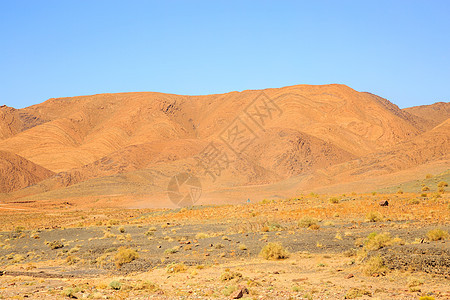 摩洛哥美丽的山地风景 在蓝天的沙漠中太阳土地晴天旅行地平线爬坡峡谷荒野干旱日落图片
