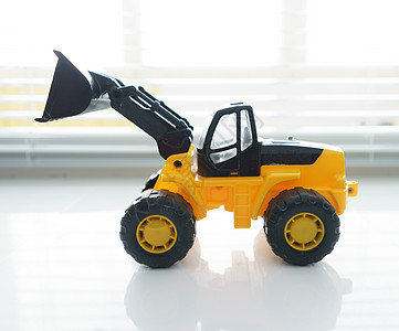 特写玩具轮装入器倾倒卡车推土机地球童年搬运工挖掘机道路承包商运输图片