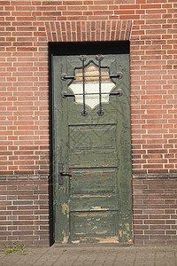 旧绿色木制门联盟房子红褐色熟料汉堡石头砖块图片