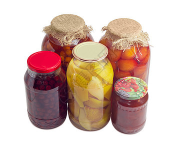 光背景玻璃罐中不同罐头的罐子水果图片