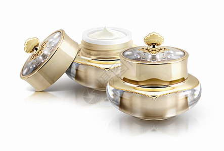 白色背景上的两个金色皇冠化妆品罐纤维奢华产品洗剂皮肤桌子玻璃雕塑圆圈化妆品图片