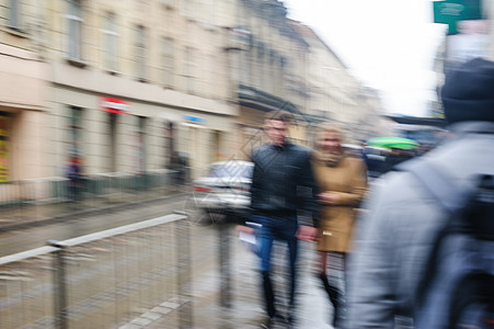 人们在雨中走在街上 注意力模糊场景行人行动黑色街道运动生活城市季节白色图片