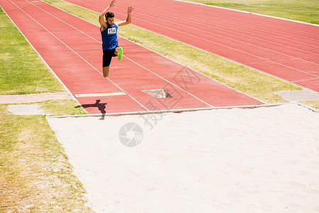 运动员跳了很长的跳男性能力竞技场地轨道跳跃男人运动跳远速度图片