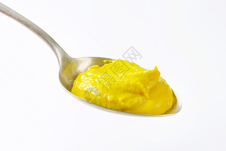 满是黄色的软骨勺子食物芥末调味品美味图片