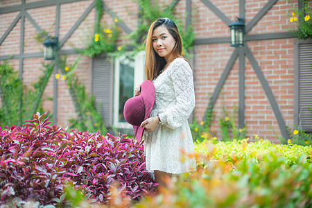 美丽的年轻的年轻女性 享受新鲜的清新绿色公园女孩帽子裙子花园白色图片