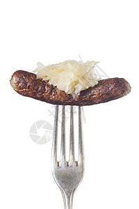 叉子上的纽伦堡香肠炙烤油炸白色酸菜刀具食物猪肉烧烤营养图片