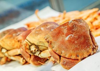 冰上一半新鲜螃蟹 在鱼市出售饮食龙虾餐厅动物钓鱼烹饪美食橙子市场海洋图片
