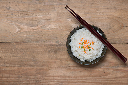 在木制桌上的碗里煮饭食物木头美食桌子粮食杯子筷子蒸汽黑色图片