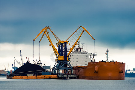 大型橘橙色货船装载物流货物运输船运库存货运加载血管进口港口图片