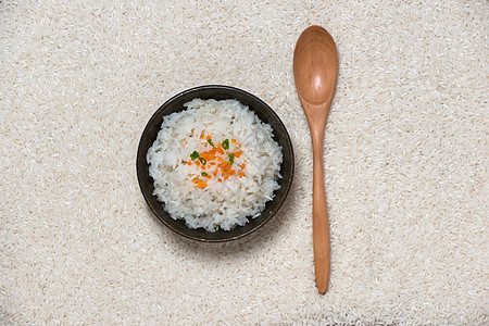 在木制桌上的碗里煮饭饮食食物粮食菜花棕色谷物勺子文化午餐美食图片