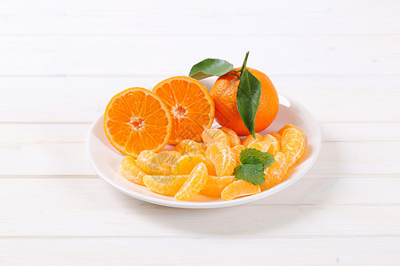 和切片的橘子去皮食物盘子水果横截面白色片段图片